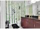 Charming bathroom features fun wallpaper, a dark vanity, and modern fixtures at 150 E Robinson St # 2002, Orlando, FL 32801