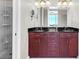 Modern bathroom featuring double sinks, sleek cabinets, and a glass-enclosed shower with corner shelves at 150 E Robinson St # 2002, Orlando, FL 32801