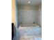Luxurious bathroom featuring a soaking tub with beautiful marble tile surround and fixtures at 150 E Robinson St # 2002, Orlando, FL 32801