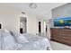 Comfortable bedroom with a view into the bathroom, closet, and a flatscreen TV at 150 E Robinson St # 2002, Orlando, FL 32801
