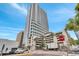 Modern high rise building with a glass facade and a parking garage in an urban setting at 150 E Robinson St # 2002, Orlando, FL 32801