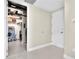 Hallway with white walls and trim leading to walk-in closet with shelving on left side at 150 E Robinson St # 2002, Orlando, FL 32801
