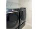 Modern laundry room showcasing front load Samsung washer and dryer in black and gold at 150 E Robinson St # 2002, Orlando, FL 32801