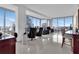 Bright living room with white floors, expansive windows showcasing city views and comfortable seating at 150 E Robinson St # 2002, Orlando, FL 32801