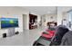 Open-concept living room with sleek furniture, a modern TV, and an adjacent kitchen area at 150 E Robinson St # 2002, Orlando, FL 32801