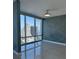 Bright living room with floor to ceiling windows showcasing city views and contemporary ceiling fan at 150 E Robinson St # 2002, Orlando, FL 32801