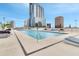 Relaxing rooftop pool with inviting lounge chairs and stunning city views at 150 E Robinson St # 2002, Orlando, FL 32801