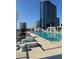 Inviting rooftop pool with lounge chairs, providing a luxurious amenity with city views at 150 E Robinson St # 2002, Orlando, FL 32801