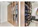 Organized walk-in closet with custom shelving, ample storage, and glass-door cabinets at 150 E Robinson St # 2002, Orlando, FL 32801