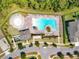 Aerial view of a neighborhood pool with a splashpad, lounge chairs, and landscaping at 15959 Pantuso Aly, Winter Garden, FL 34787