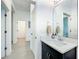 Bright bathroom featuring a vanity and mirror with a hallway view at 15959 Pantuso Aly, Winter Garden, FL 34787