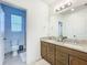 Bathroom with a double vanity, granite countertops and tile floors at 15959 Pantuso Aly, Winter Garden, FL 34787