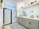 Modern bathroom featuring a glass shower and a double vanity sink with ample counter space at 15959 Pantuso Aly, Winter Garden, FL 34787