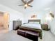 Spacious bedroom with neutral walls, carpet flooring, a ceiling fan, and wooden furniture at 15959 Pantuso Aly, Winter Garden, FL 34787