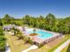 Resort-style community pool and splashpad surrounded by lush landscaping and mature trees at 15959 Pantuso Aly, Winter Garden, FL 34787