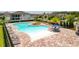 Beautiful community pool with plenty of seating, palm trees, and a unique brick patio at 15959 Pantuso Aly, Winter Garden, FL 34787