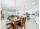 Dining area with a table and bench next to an open kitchen and a living room at 15959 Pantuso Aly, Winter Garden, FL 34787