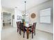Bright dining room features a modern chandelier, wood table, and light wood-look tile floors at 15959 Pantuso Aly, Winter Garden, FL 34787