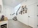 Inviting foyer with staircase, modern flooring, and gallery wall with Gathering photos at 15959 Pantuso Aly, Winter Garden, FL 34787