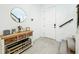 Charming foyer with light wood floors, console table, and decorative round mirror at 15959 Pantuso Aly, Winter Garden, FL 34787
