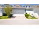 Two-car garage with brick paver driveway and manicured landscaping at 15959 Pantuso Aly, Winter Garden, FL 34787