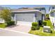 Two-car garage with brick paver driveway and manicured landscaping at 15959 Pantuso Aly, Winter Garden, FL 34787