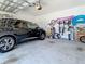This garage features storage space, bikes hanging on the wall, and a parked car at 15959 Pantuso Aly, Winter Garden, FL 34787
