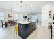 Open kitchen featuring a large island with seating and a sink, open to the dining room at 15959 Pantuso Aly, Winter Garden, FL 34787
