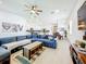 Spacious open-concept living room boasts a large blue sectional sofa and hardwood floors at 15959 Pantuso Aly, Winter Garden, FL 34787