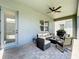 Covered patio with ceiling fan and comfortable seating at 15959 Pantuso Aly, Winter Garden, FL 34787