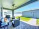 Comfortable covered patio with brick pavers, ceiling fan, grill, and backyard access at 15959 Pantuso Aly, Winter Garden, FL 34787