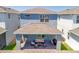 Rear exterior view of home with covered patio and manicured yard at 15959 Pantuso Aly, Winter Garden, FL 34787