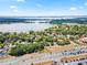 Scenic aerial view captures the home's setting near a lake, roads, and the surrounding area at 1650 Old Eustis Rd, Mount Dora, FL 32757
