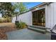 Exterior backyard view with patio, steps, siding, and lush plants at 1650 Old Eustis Rd, Mount Dora, FL 32757