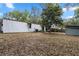 Large backyard with a corrugated metal building and shed, offering ample outdoor space at 1650 Old Eustis Rd, Mount Dora, FL 32757