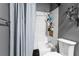 Bathroom featuring a shower/tub combo with white tile surround and gray walls at 1650 Old Eustis Rd, Mount Dora, FL 32757