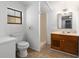 Bathroom featuring a toilet, shower, wood vanity with marble counter, and a mirror at 1650 Old Eustis Rd, Mount Dora, FL 32757