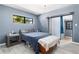 Comfortable bedroom with a queen-sized bed, light blue walls, and a sliding door, creating a tranquil and airy space at 1650 Old Eustis Rd, Mount Dora, FL 32757