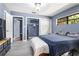 Cozy bedroom with natural light, featuring wood-look flooring and ample storage with closet doors, offering a comfortable retreat at 1650 Old Eustis Rd, Mount Dora, FL 32757