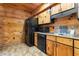 Efficient kitchen area with knotty pine cabinets, modern appliances, and tiled flooring at 1650 Old Eustis Rd, Mount Dora, FL 32757