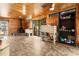 Open-concept living area features wood-paneled walls, a fireplace, and tile flooring, creating a spacious and inviting atmosphere at 1650 Old Eustis Rd, Mount Dora, FL 32757