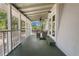 Inviting screened porch with seating, ceiling fan, and views of the landscaped yard at 1650 Old Eustis Rd, Mount Dora, FL 32757
