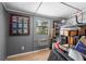 Functional storage room featuring wood-paneled walls, a window, and ample space for organization, ensuring a clutter-free home at 1650 Old Eustis Rd, Mount Dora, FL 32757