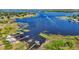 Stunning aerial view showcases the lakefront property, docks and lush greenery at 17226 Hickory Wind Dr, Clermont, FL 34711