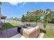 Spacious backyard featuring a brick paver patio with outdoor furniture, fire pit, and well-kept lawn at 17226 Hickory Wind Dr, Clermont, FL 34711