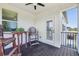 Cozy balcony with wooden chairs, table, and a view of the neighborhood, creating a perfect outdoor retreat at 17226 Hickory Wind Dr, Clermont, FL 34711