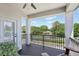 Relaxing covered balcony features sturdy black metal railing and a serene view of the neighborhood at 17226 Hickory Wind Dr, Clermont, FL 34711