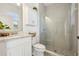 Modern bathroom with glass shower door, natural stone accents, and a sleek white vanity at 17226 Hickory Wind Dr, Clermont, FL 34711