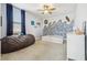 Charming bedroom with a ceiling fan, featuring a wave-themed wall design and blue accents at 17226 Hickory Wind Dr, Clermont, FL 34711