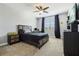 Cozy bedroom with a ceiling fan, complemented by gray walls and carpet, with matching curtains and furniture at 17226 Hickory Wind Dr, Clermont, FL 34711